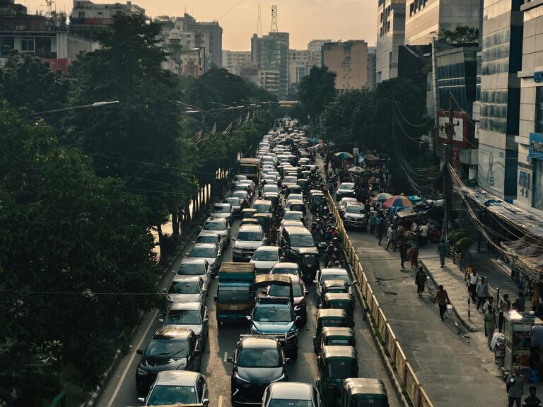 Aerial view of heavy traffic jam on a busy street in Dhaka, Bangladesh at sunset.