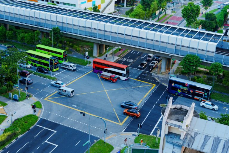High angle view of a busy intersection with buses and cars in a cityscape setting.