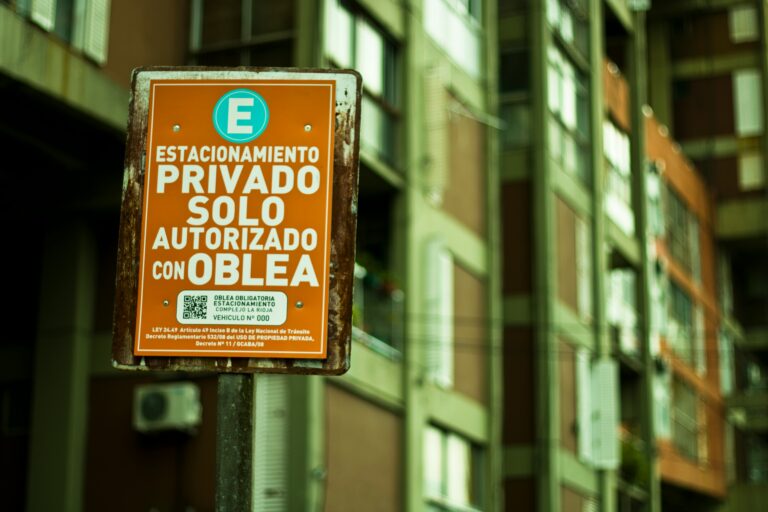 a sign on a pole in front of a building